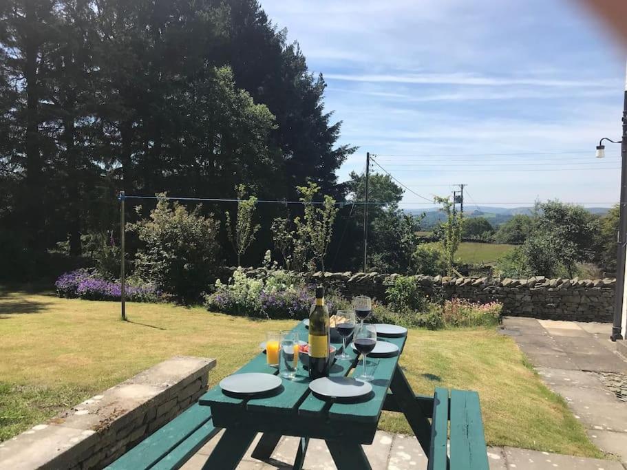 a picnic table with a bottle of wine on it at Hayfellside Cottage, Sleep 6,3 Bedrooms(1 ensuite) in Kendal