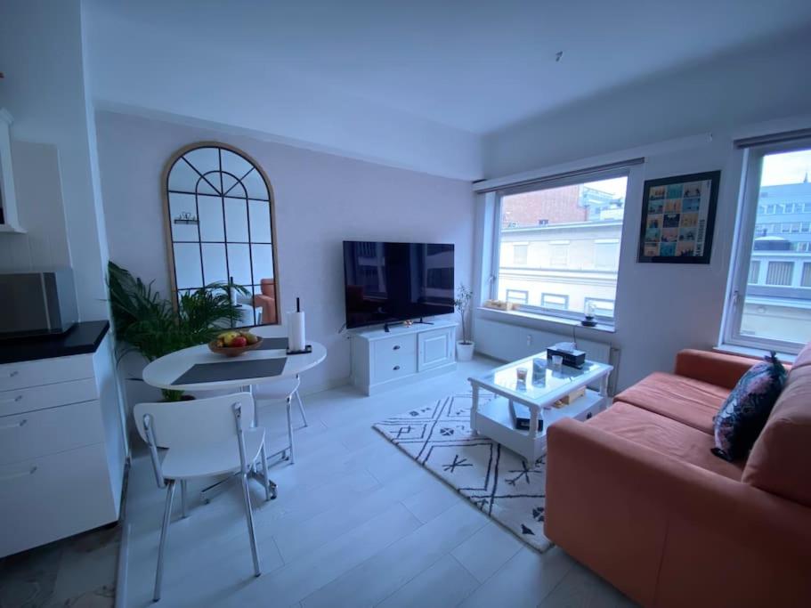 a living room with a couch and a table at Lovely condo next to European Area in Brussels