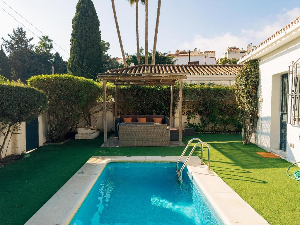 a swimming pool in a yard with a gazebo at Charming country house Torremolinos in Torremolinos