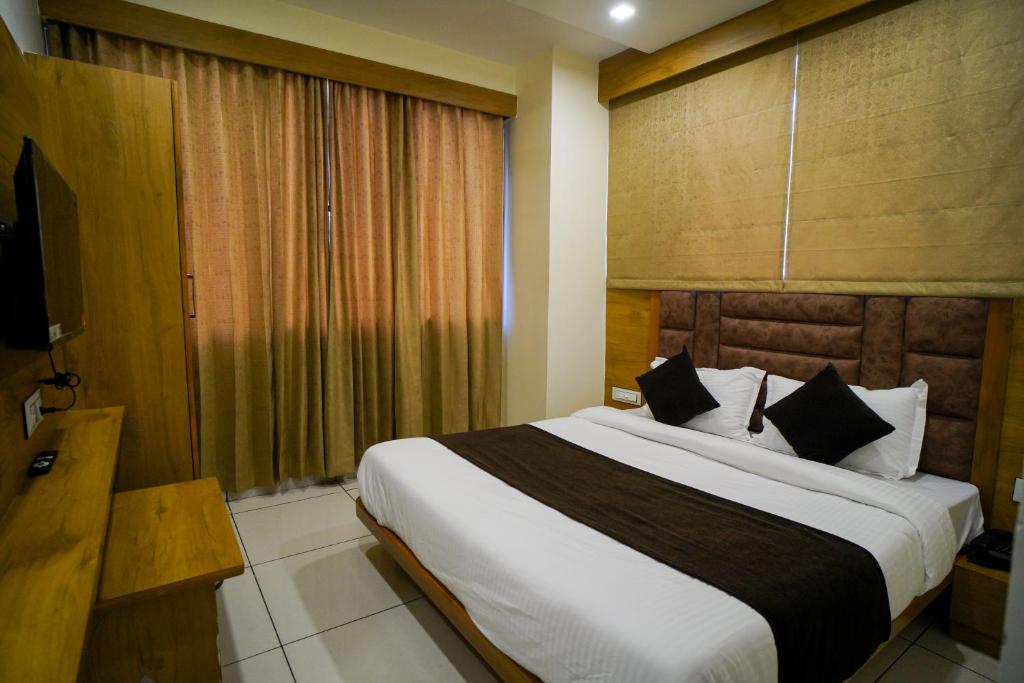 Postel nebo postele na pokoji v ubytování Hotel Suncity