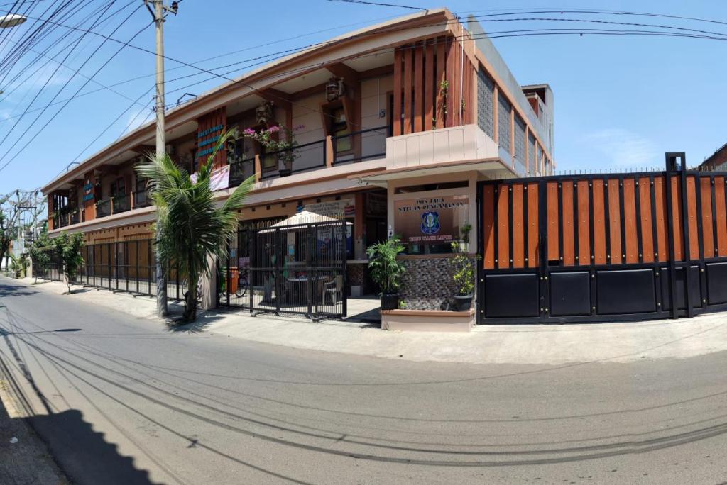 a building on the side of a street at pondok Syariah Hadikusuma 