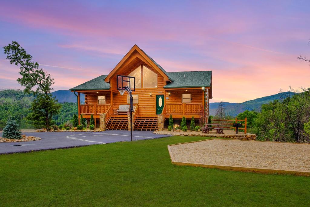 a cabin in the mountains with a grass yard at Bella Vista Lodge in Gatlinburg