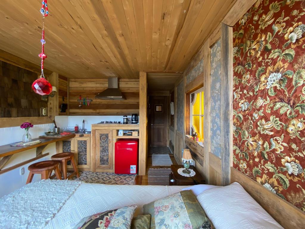 a bedroom in a tiny house with a kitchen at Palafito Ayün in Castro