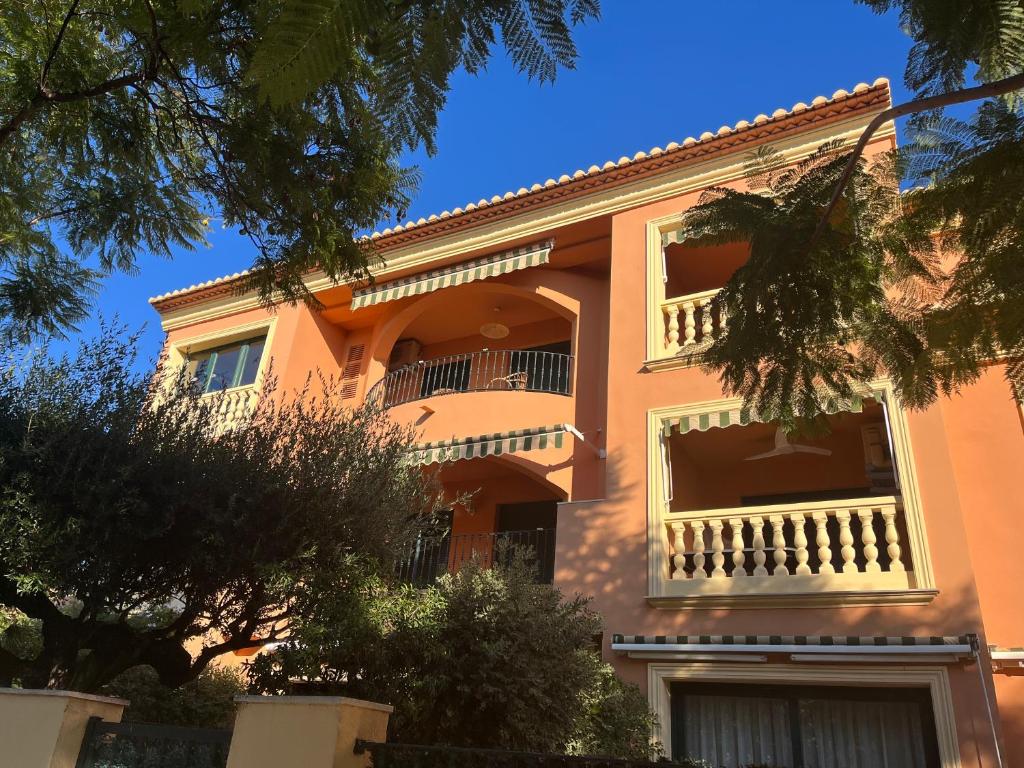a large orange building with a balcony at apartment nearby beach and old town Javea in Jávea