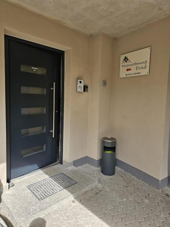 a black door in a room with a trash can at Ferienwohnung Erna in Marktoberdorf