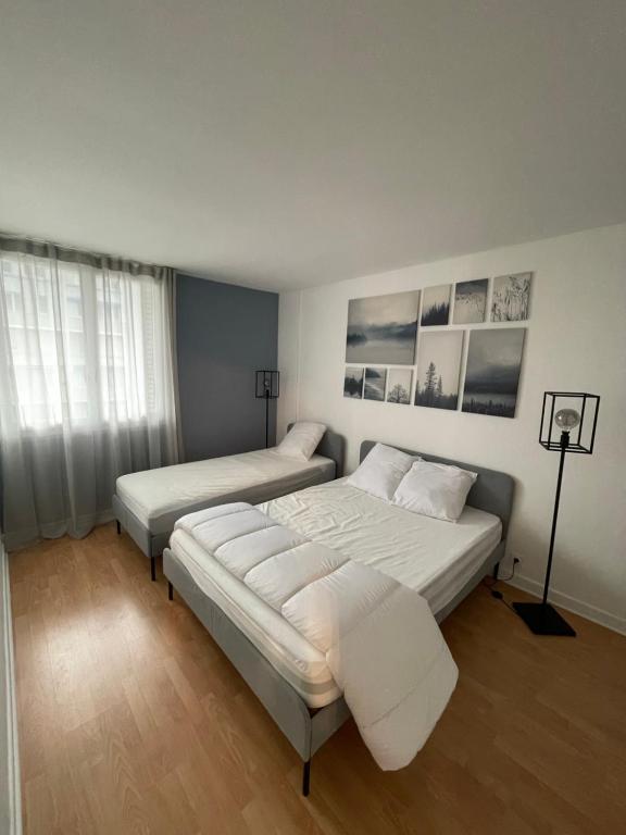 En eller flere senge i et værelse på magnifique Duplex avec 2 chambres et parking gratuit