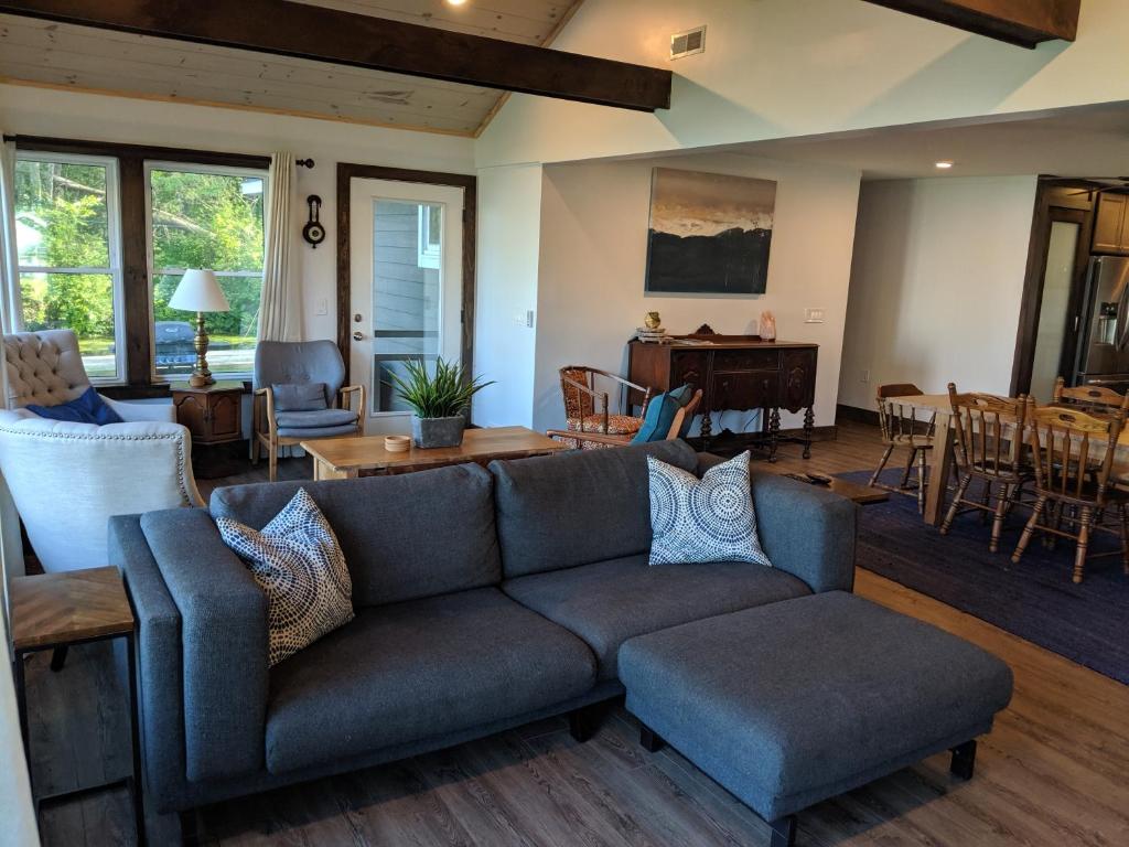 a living room with a couch and a table at Whitney Bay House on CHQ Lake in Mayville