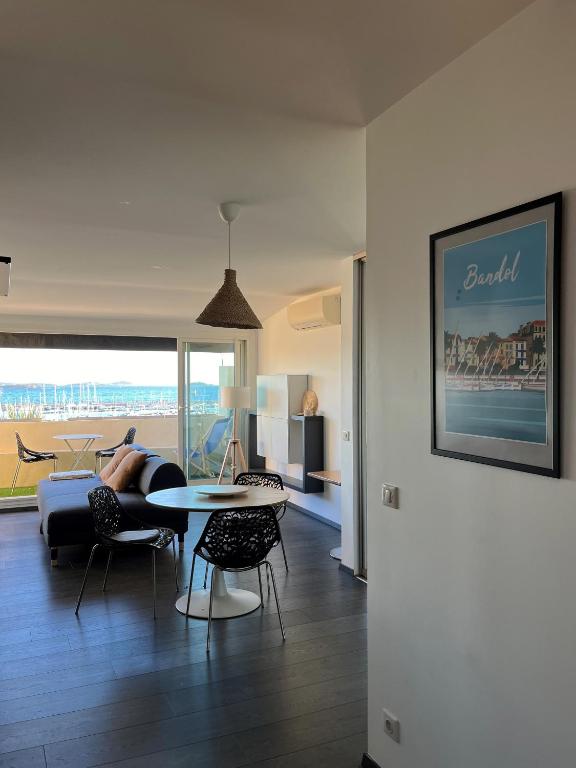 a person laying on a couch in a living room at Appartement sur le port vue Mer in Bandol