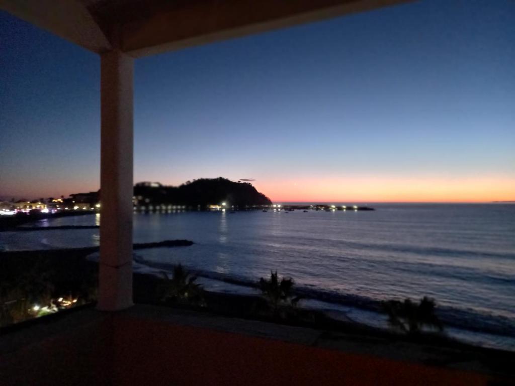 a view of the ocean at night from a balcony at Attico Vista Mare Sestri Levante in Sestri Levante