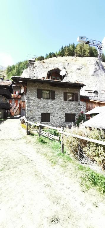 an old brick house with a snow covered roof at Maison Sarteur Alloggio ad uso turistico -VDA-LA THUILE- 0065 in La Thuile