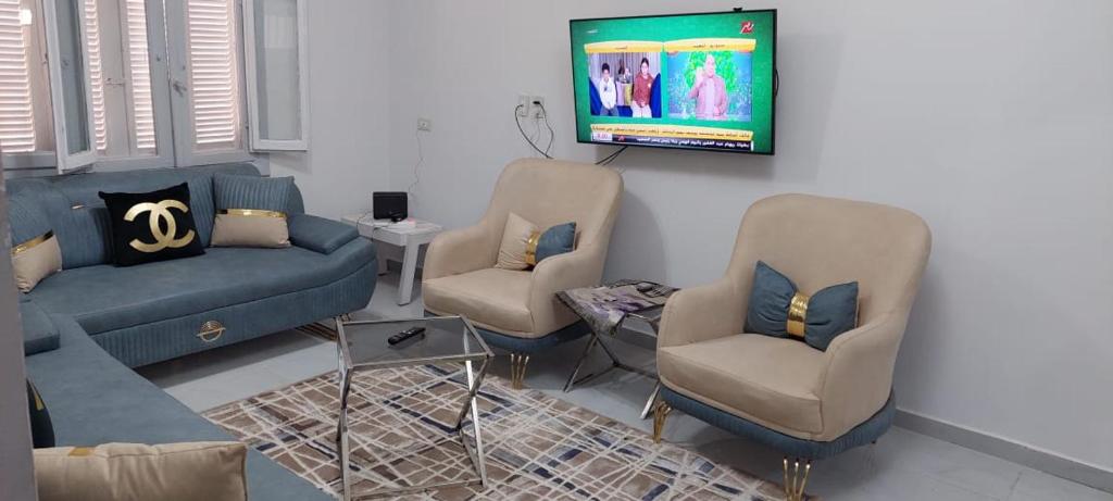a living room with a couch and two chairs at Nasr city Cozy Studio _ 2 bedrooms in Cairo
