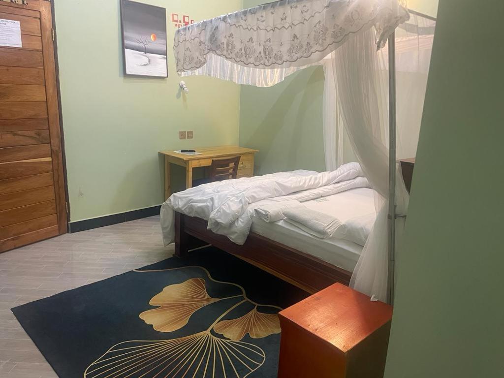 a bedroom with a bed with a canopy at The first royal tour lodge in Dodoma