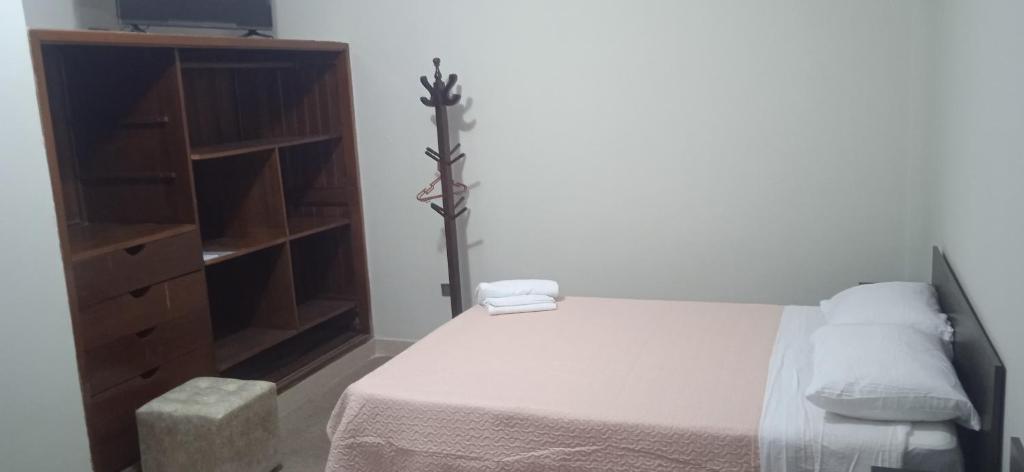 a bedroom with a bed and a dresser at Los Kristales in Tingo María