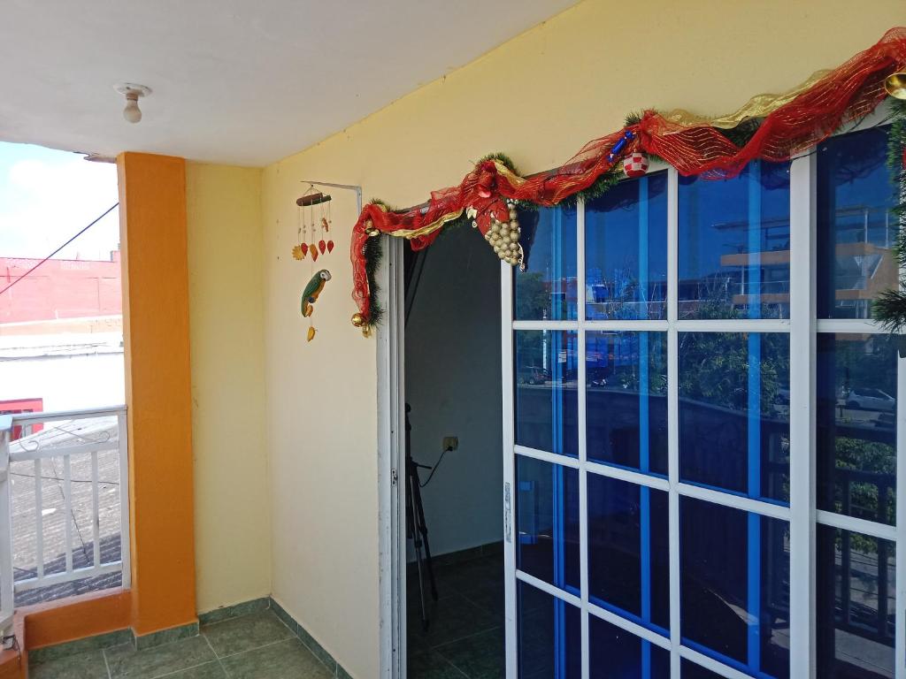 a room with a large window and a door at Alojamiento Casa Luz Cielo in Puerto Colombia