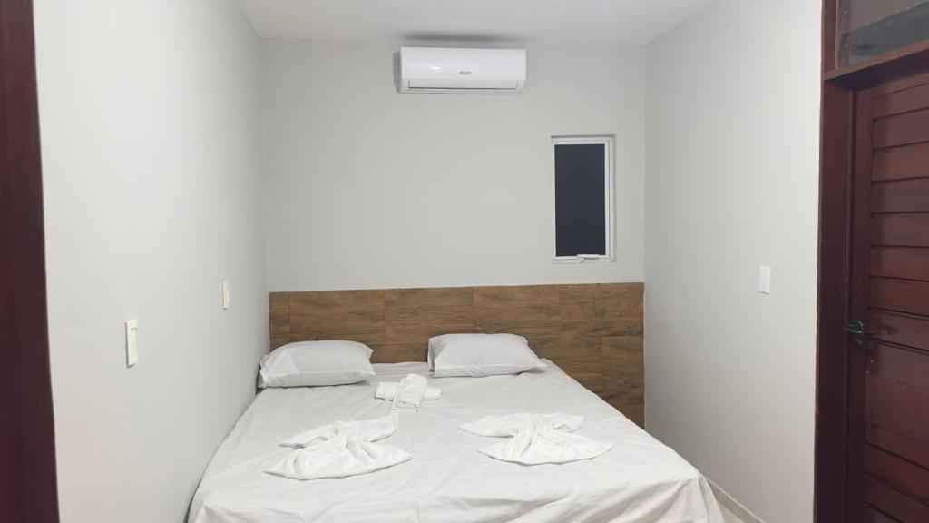 Postel nebo postele na pokoji v ubytování Suítes Tambaú