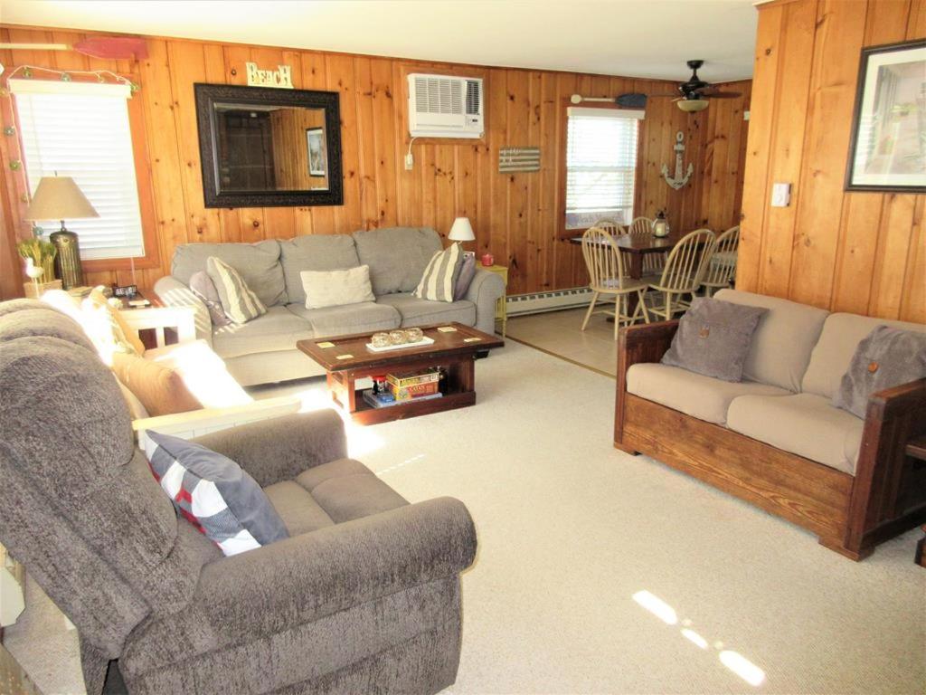 a living room with two couches and a table at Upgraded 2Nd Floor Duplex In The Heart Of Harvey Cedars Close To The Bay Beach And The Ocean in Harvey Cedars