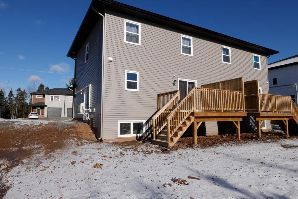 une maison avec une grande terrasse devant elle dans l'établissement Luxury Homes In Moncton!, à Moncton