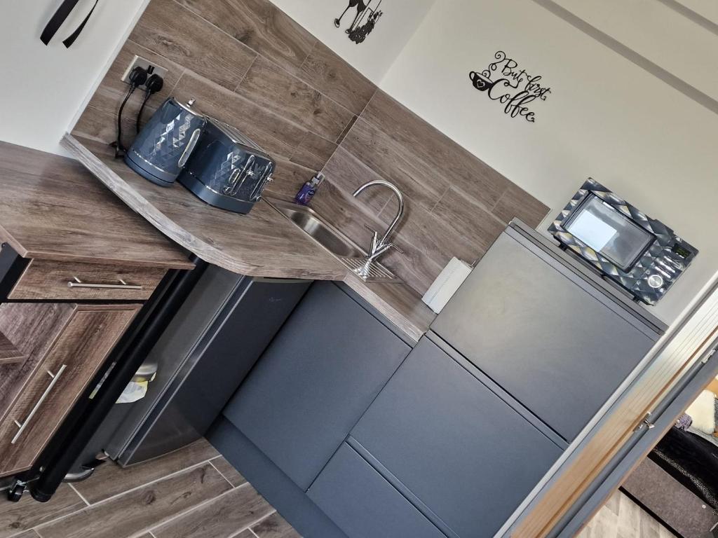 a kitchen with a counter top with a sink at Seabreeze The Annexe in Blackpool