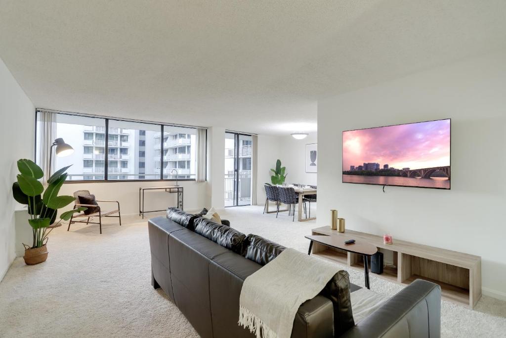 a living room with a couch and a table at Convenient Airport Proximity: Apt in Crystal City in Arlington