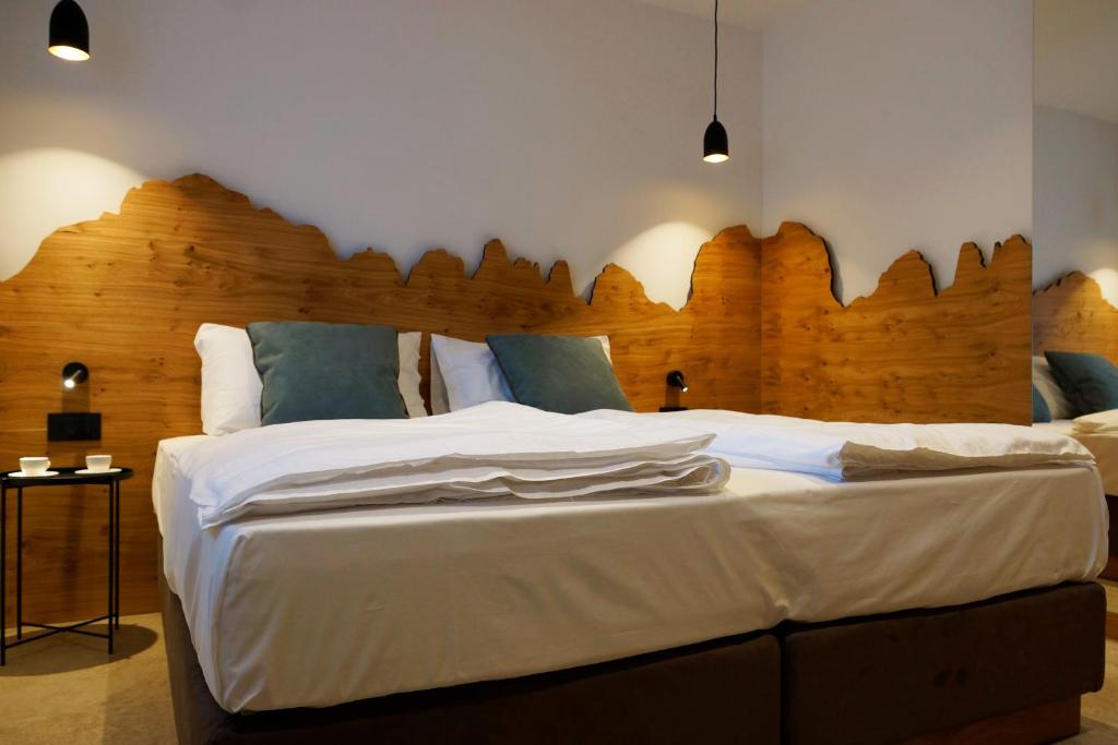 Postel nebo postele na pokoji v ubytování Chalet Larix Andalo Deluxe Apartments