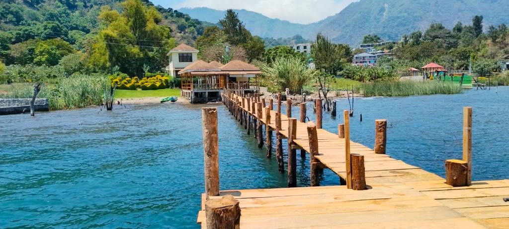 a dock on a lake with a house on it at Hotel Casa Ki'iil, San Juan La Laguna,Sololá, Guatemala in San Juan La Laguna