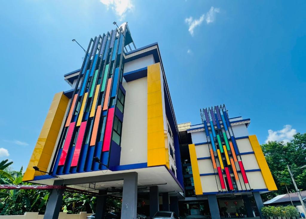 a building with colorful paint on the side of it at Ma Chic & Cozy in Lampang