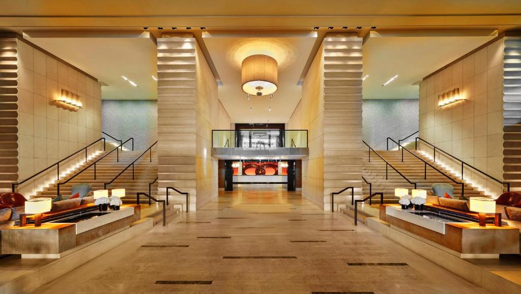 a lobby of a hotel with stairs and a lobby at InterContinental Genève, an IHG Hotel in Geneva