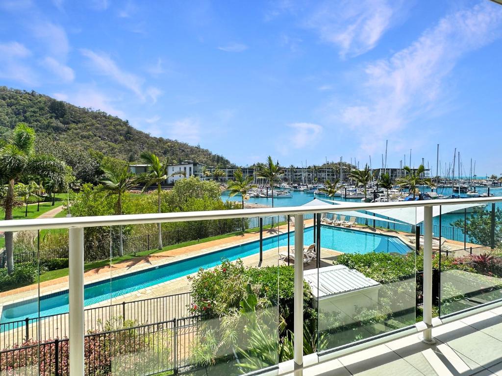 a balcony with a view of a marina at Waterfront 'Beachside' Apartment - Ocean View, Central location, Pool, Wifi, King bed, Deluxe Spa Ensuite in Nelly Bay