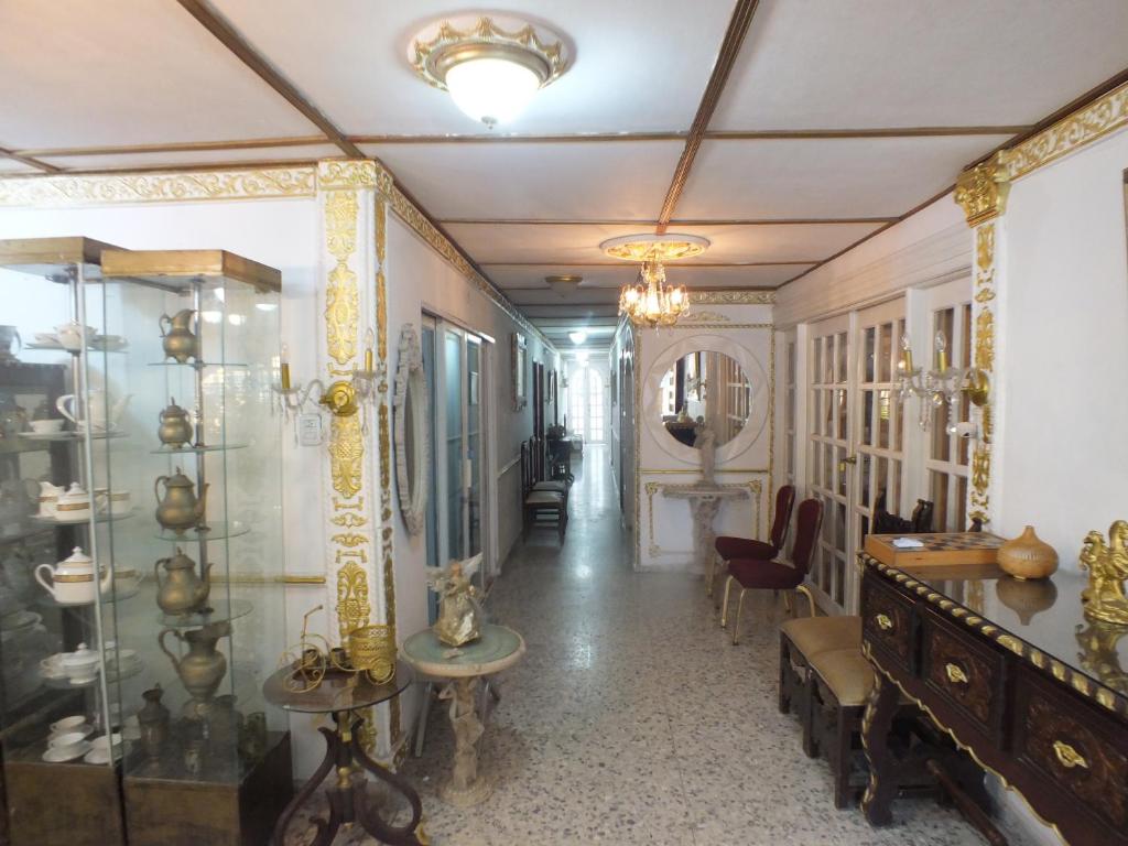 a hallway with a room filled with items on display at Hotel Alto de los Nogales in Barranquilla