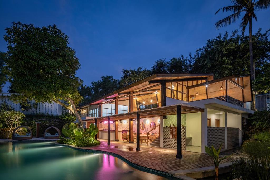 a house with a pool in front of it at Deep Roots Dive & Yoga Resort in Nusa Penida