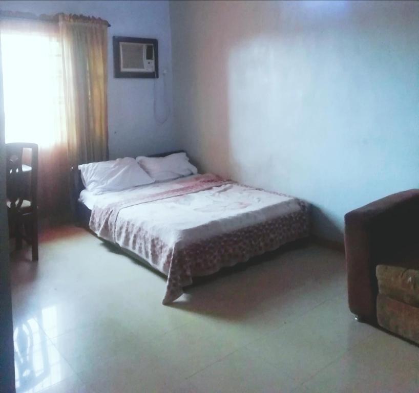 a bedroom with a bed in a room with a window at Diamond Hotel close to Intl Airport, omole ikeja in Mawere