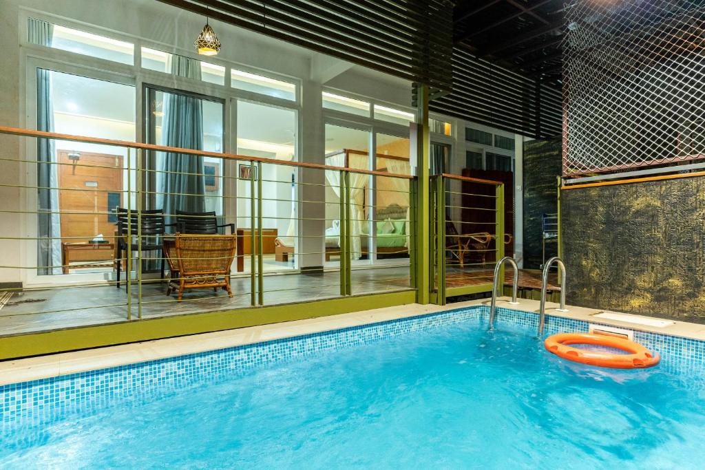 a large swimming pool with a lifebuoy in it at Kuruva Island Resort And Spa - By KABINI BREEZE, Wayanad in Mananthavady