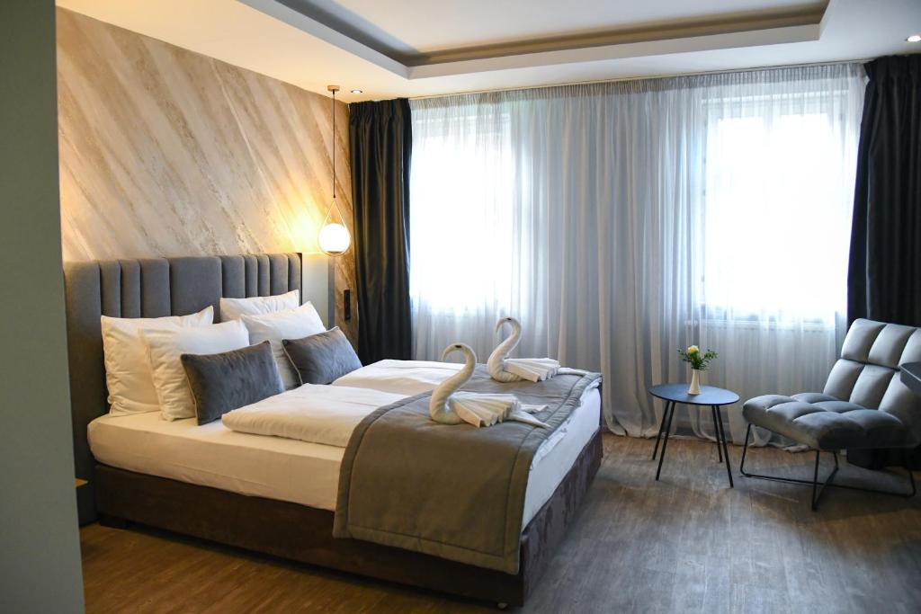 una camera da letto con un letto con due cigni sopra di Hotel Zum Weissen Ross a Delitzsch