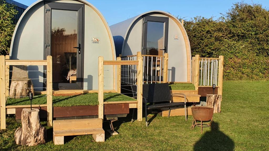 a couple of arched homes in the grass at "PONY POD" at Nelson Park Riding Centre Ltd in Kent