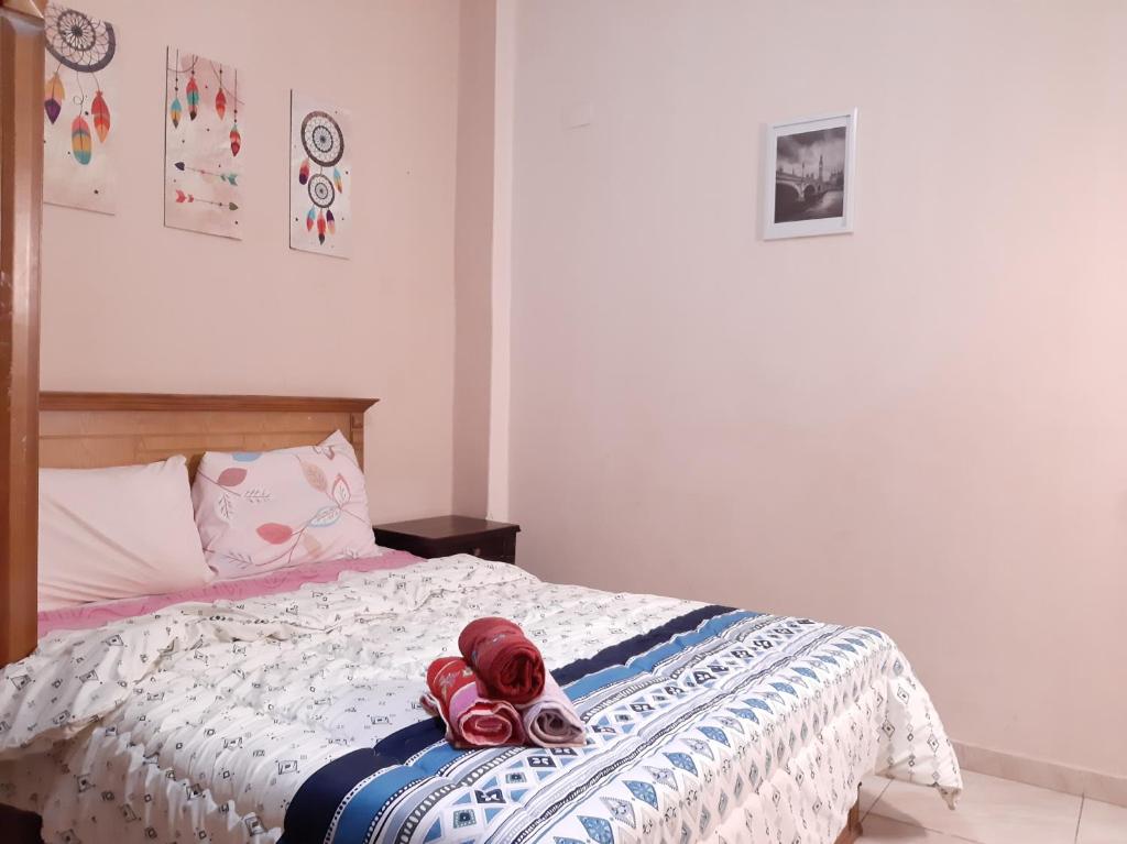 a bedroom with a bed with red stuffed animals on it at Family Apartment - Downtown Cairo in Cairo