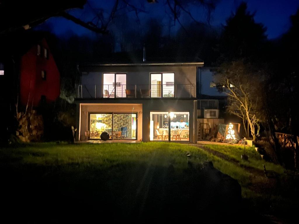 a house at night with the lights on at Ferienhaus Waldbaden im Nationalpark Eifel- am Bach in Schleiden
