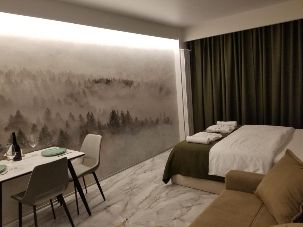 sypialnia z łóżkiem, stołem i krzesłami w obiekcie Segreto apartment 309, 311, 341 w mieście Gudauri
