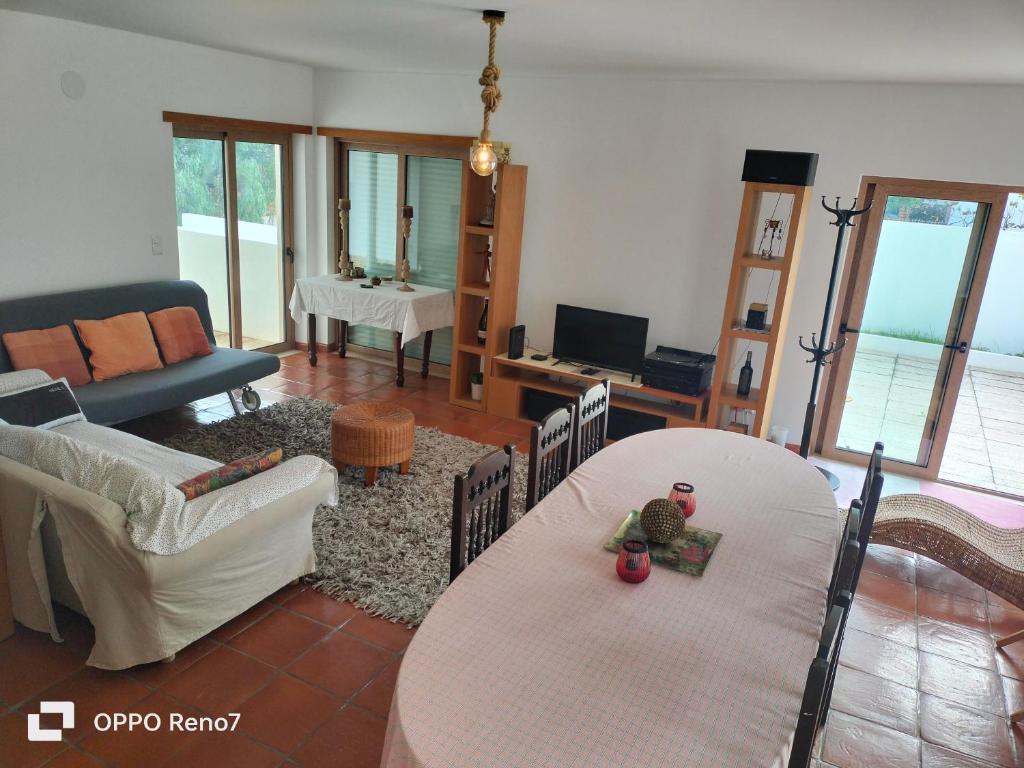 a living room with a table and a couch at Residencial Monte Gordo Golf Rei Algarve in Monte Gordo