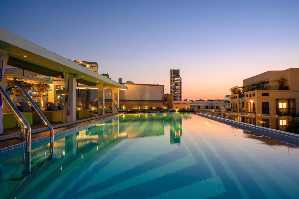 a large swimming pool on top of a building at Poli House by AFI Hotels in Tel Aviv