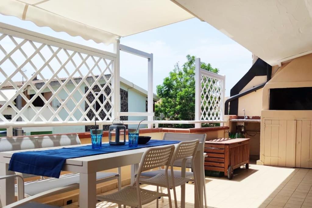 a patio with a table and chairs on a patio at Moby Dick House in Villasimius