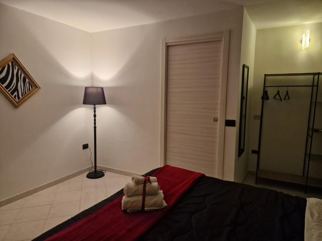 a bedroom with a bed with two towels on it at Pontecorvo Naples Apartament in Naples