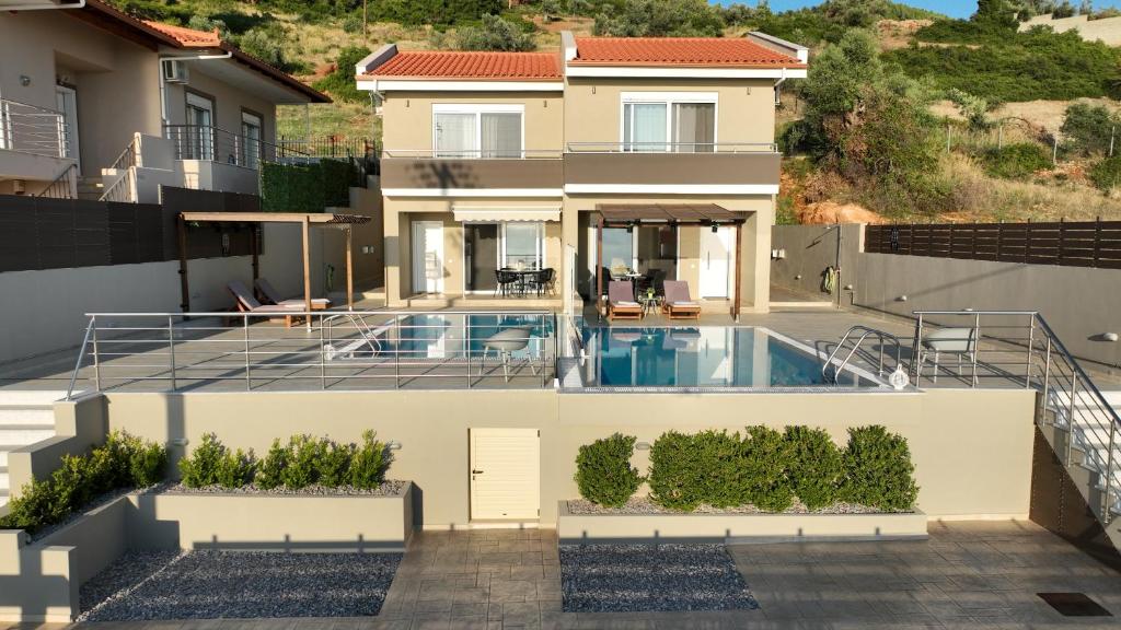 a house with a swimming pool on top of it at Lila's villa maisonette with private pool in Nerotriviá