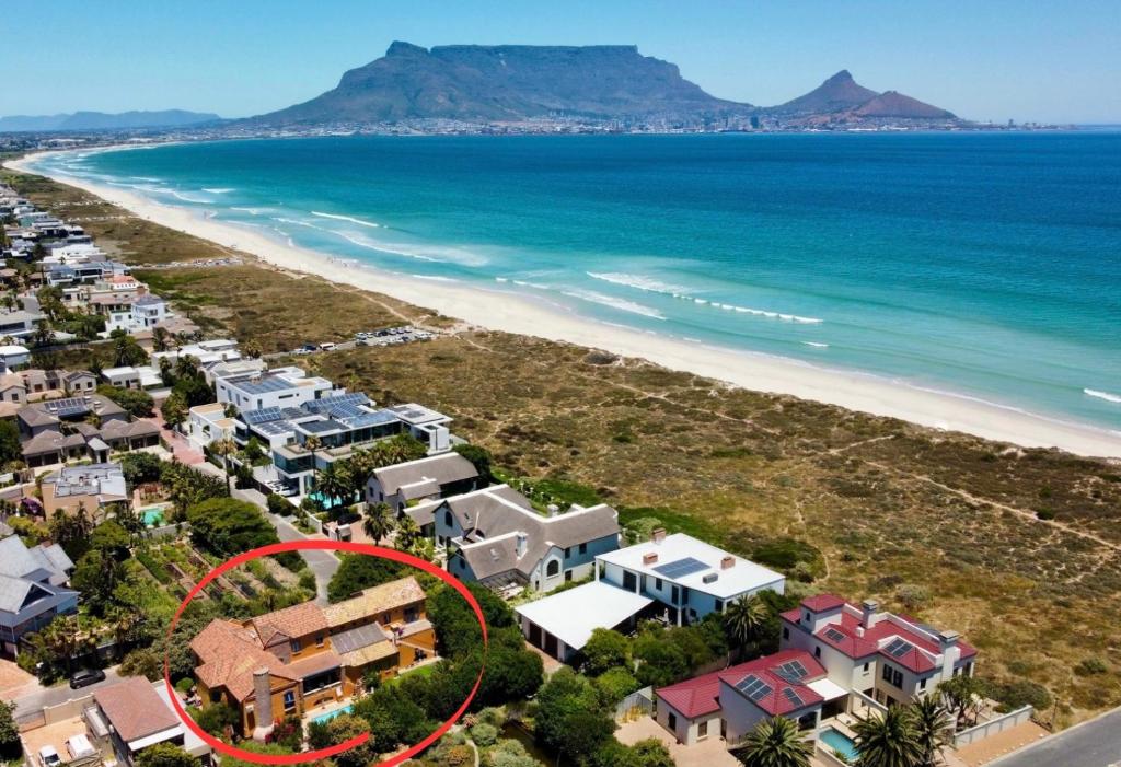 an aerial view of a house next to the beach at Sunset Beach holiday accommodation in Cape Town