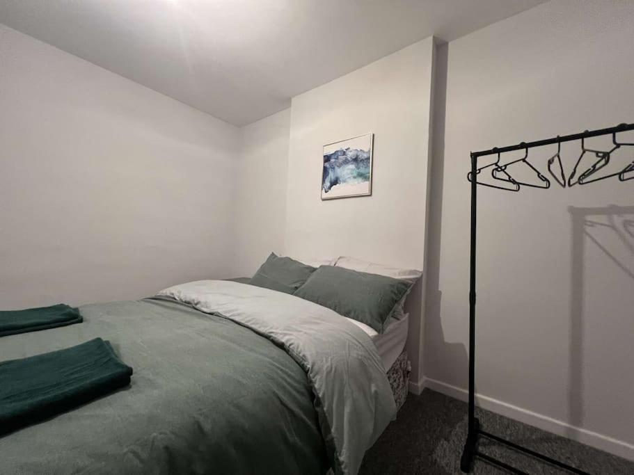 a bedroom with a bed in a white room at Home in Sheffield City Centre in Heeley