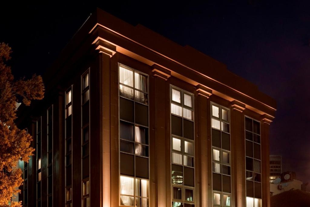 a building with illuminated windows at night at Casa Suzanna Hotel in Tel Aviv