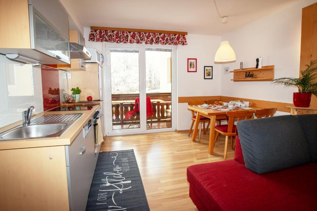 a kitchen and a living room with a table and a kitchen at Gästehaus Seewinkel in Lake Pressegg