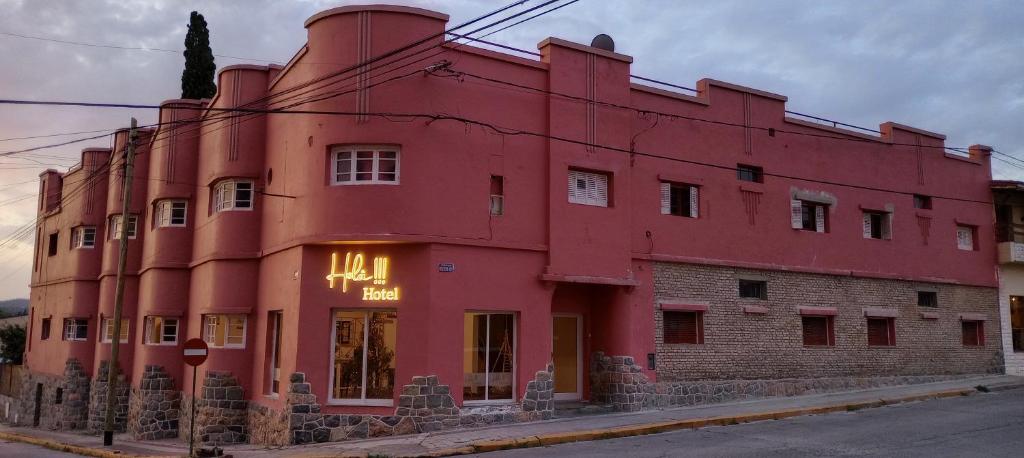 a red building on the side of a street at Holâ Hotel in La Falda