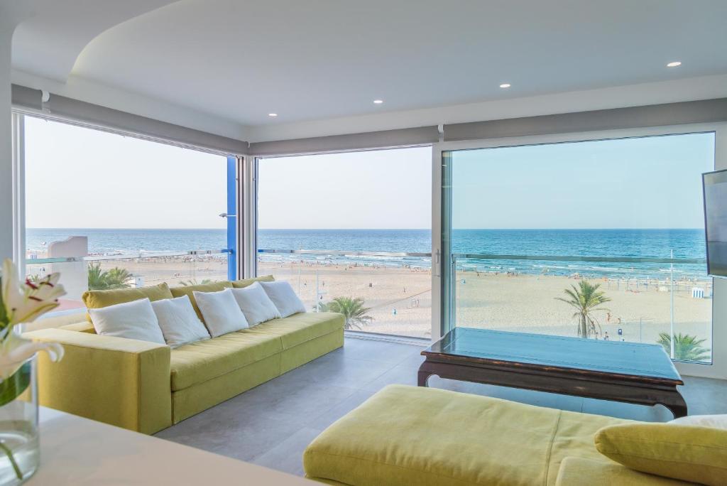 a living room with a couch and a view of the beach at Marbell in Gandía