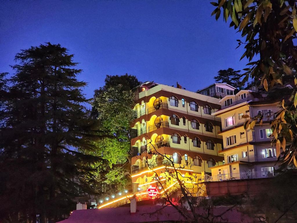 a building with lights on it at night at Hotel Taj Palace near Mall Road in Shimla