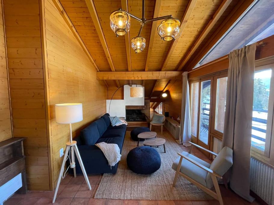 ein Wohnzimmer mit einem blauen Sofa in einem Zimmer in der Unterkunft Appartement 5 ch. Ski-in/out in Verbier